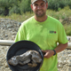 Gold miner Neil Loveless with the wolf pup he found.